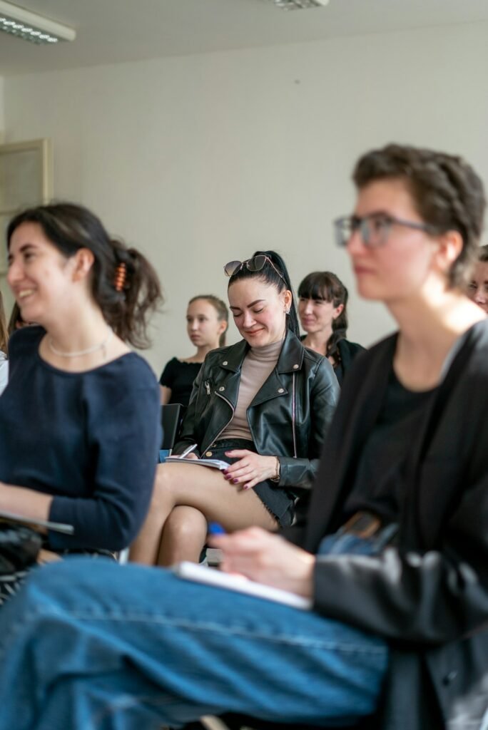 Audience members engaging attentively during a seminar on handling workplace incidents.